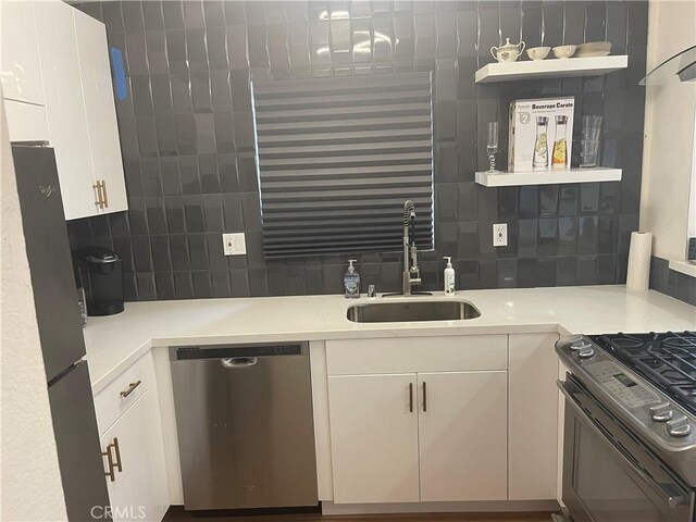 1192 Mitchell Unit 7, Tustin, CA 92780 - kitchen with stainless steel appliances, backsplash, open shelves, light countertops, and white cabinets