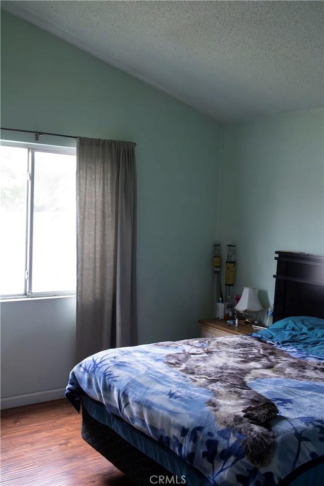 895 Garner Ave, San Bernardino, CA 92411 - bedroom featuring wood finished floors, a textured ceiling, and lofted ceiling
