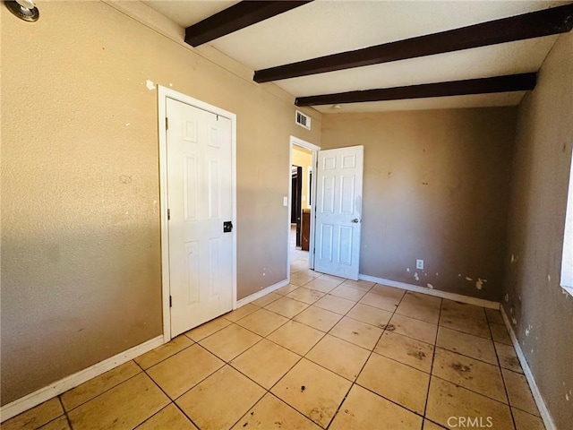 27331 Perkins Rd, Madera, CA 93637 - spare room featuring light tile patterned floors and beamed ceiling