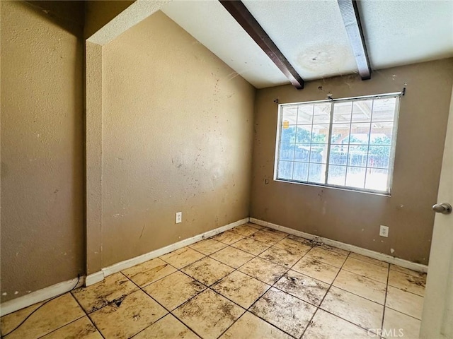 27331 Perkins Rd, Madera, CA 93637 - spare room featuring beam ceiling and light tile patterned flooring