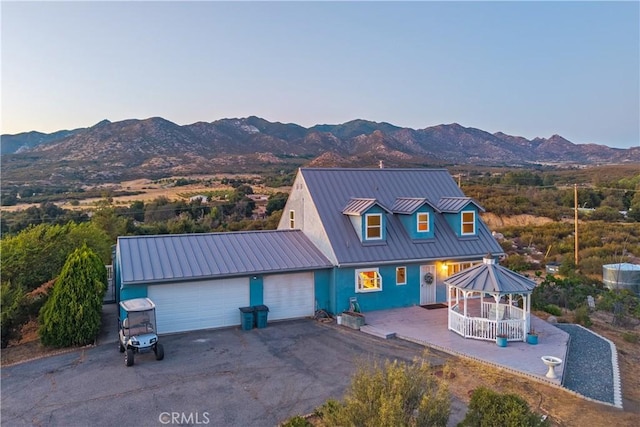 36227 Montezuma Valley Rd, Ranchita, CA 92066 - view of front of home featuring a mountain view, a metal roof, an attached garage, and driveway