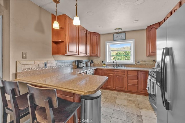 36227 Montezuma Valley Rd, Ranchita, CA 92066 - kitchen featuring appliances with stainless steel finishes, a peninsula, a breakfast bar, and light countertops