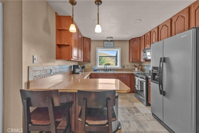 36227 Montezuma Valley Rd, Ranchita, CA 92066 - kitchen with appliances with stainless steel finishes, a peninsula, light countertops, open shelves, and a kitchen bar