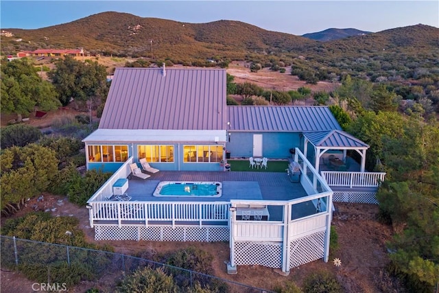 36227 Montezuma Valley Rd, Ranchita, CA 92066 - rear view of property featuring a deck with mountain view, a covered pool, a metal roof, and a standing seam roof