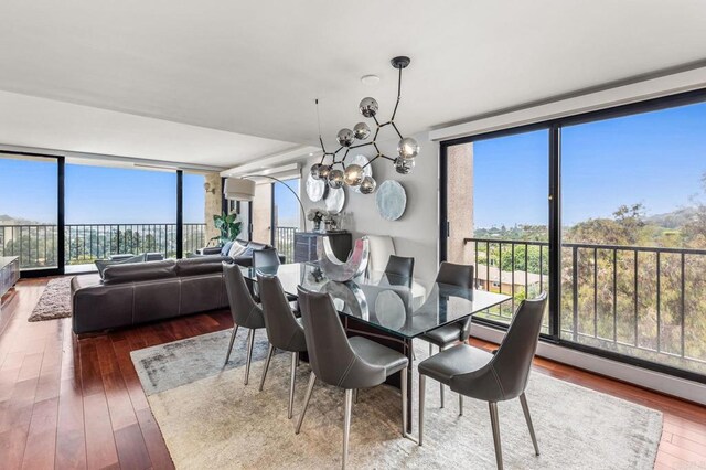 2500 Torrey Pines Rd Unit 805, La Jolla, CA 92037 - dining room with hardwood / wood-style floors, a wall of windows, a chandelier, and a baseboard radiator