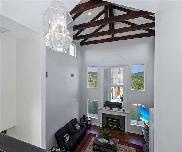 40620 Via Ranchitos, Fallbrook, CA 92028 - living area with high vaulted ceiling, beamed ceiling, wood finished floors, a chandelier, and a glass covered fireplace