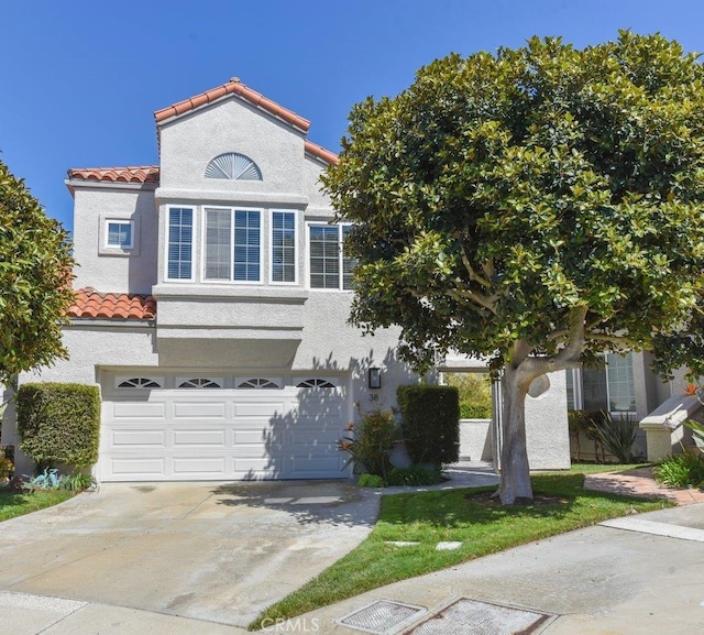 38 Toulon, Laguna Niguel, CA 92677 - view of front of home with a tiled roof, driveway, an attached garage, and stucco siding