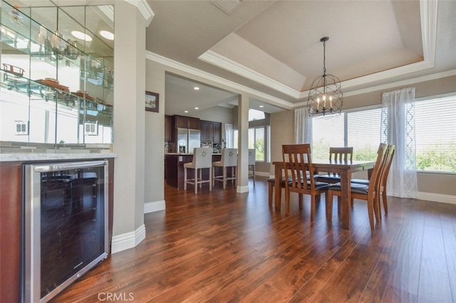 38 Toulon, Laguna Niguel, CA 92677 - dining space with wine cooler, a chandelier, dark wood finished floors, crown molding, and a tray ceiling