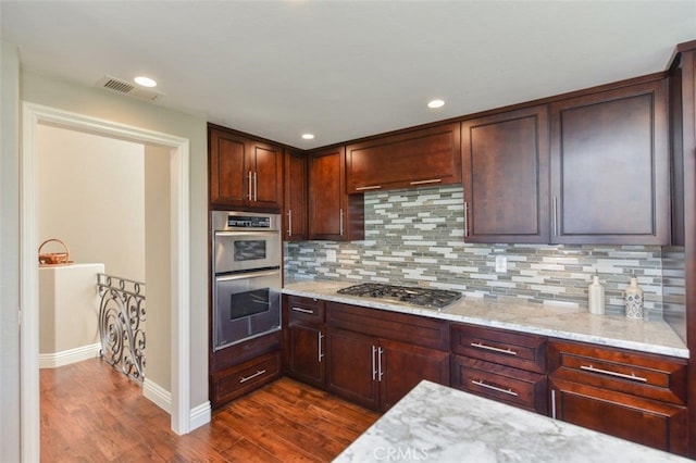 38 Toulon, Laguna Niguel, CA 92677 - kitchen featuring stainless steel appliances, dark wood finished floors, light stone counters, and recessed lighting