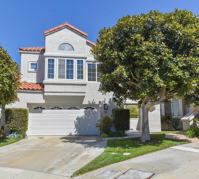 38 Toulon, Laguna Niguel, CA 92677 - view of front of property featuring a tile roof, concrete driveway, a garage, and stucco siding