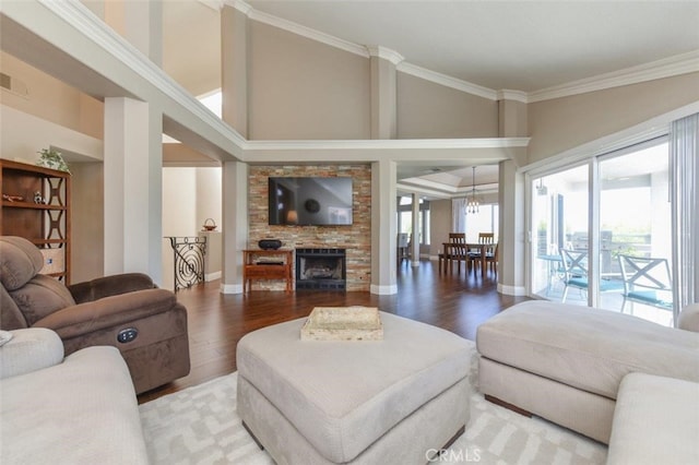 38 Toulon, Laguna Niguel, CA 92677 - living room featuring wood finished floors, crown molding, a large fireplace, and a towering ceiling