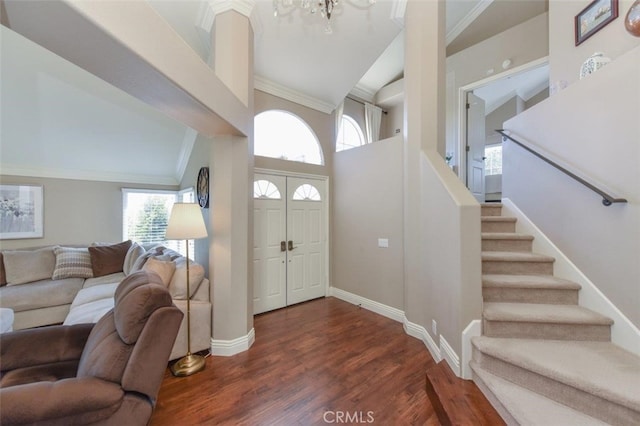 38 Toulon, Laguna Niguel, CA 92677 - foyer featuring crown molding, dark wood-style floors, stairs, a towering ceiling, and a chandelier