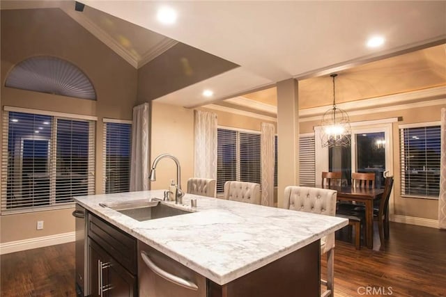 38 Toulon, Laguna Niguel, CA 92677 - kitchen with stainless steel dishwasher, dark wood-style floors, ornamental molding, decorative light fixtures, and light stone countertops
