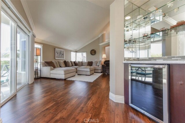 38 Toulon, Laguna Niguel, CA 92677 - living room featuring beverage cooler, ornamental molding, dark wood-style flooring, and lofted ceiling