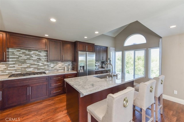 38 Toulon, Laguna Niguel, CA 92677 - kitchen with stainless steel appliances, dark wood finished floors, backsplash, a breakfast bar, and lofted ceiling