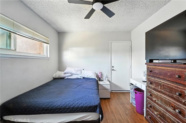 9562 Locust Ave, Fontana, CA 92335 - bedroom featuring wood finished floors, a textured ceiling, and ceiling fan