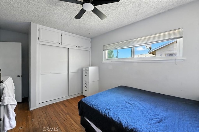 9562 Locust Ave, Fontana, CA 92335 - bedroom featuring dark wood-style floors, a textured ceiling, a ceiling fan, and a closet