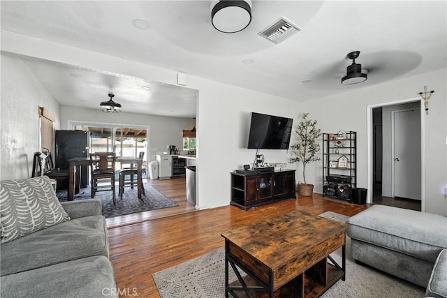 9562 Locust Ave, Fontana, CA 92335 - living area featuring wood finished floors and ceiling fan