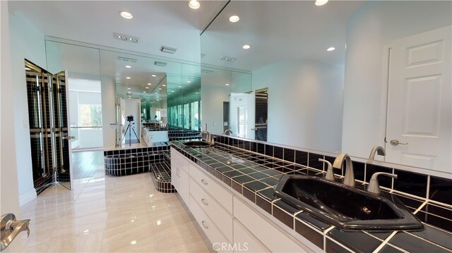 22500 N Summit Ridge Cir, Chatsworth, CA 91311 - bathroom with a garden tub, double vanity, and recessed lighting