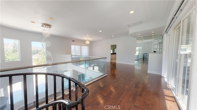 22500 N Summit Ridge Cir, Chatsworth, CA 91311 - hall featuring plenty of natural light, wood-type flooring, recessed lighting, a chandelier, and an upstairs landing