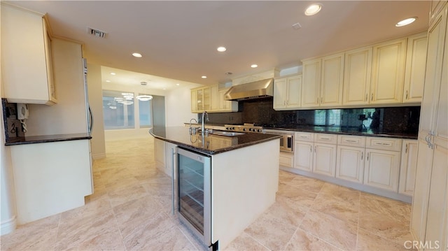 22500 N Summit Ridge Cir, Chatsworth, CA 91311 - kitchen with wine cooler, wall chimney exhaust hood, recessed lighting, backsplash, and dark stone counters