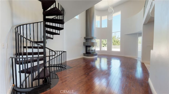 22500 N Summit Ridge Cir, Chatsworth, CA 91311 - stairway featuring a high ceiling, wood finished floors, and a chandelier