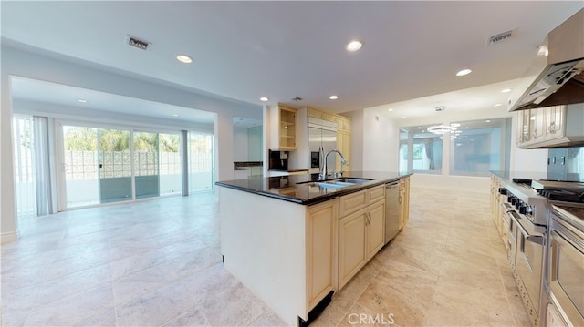22500 N Summit Ridge Cir, Chatsworth, CA 91311 - kitchen with range hood, stainless steel appliances, cream cabinets, recessed lighting, and a kitchen island with sink