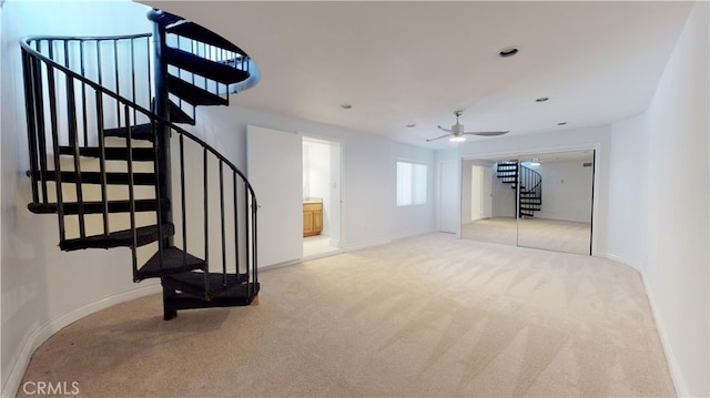 22500 N Summit Ridge Cir, Chatsworth, CA 91311 - unfurnished living room with stairs, carpet floors, and a ceiling fan