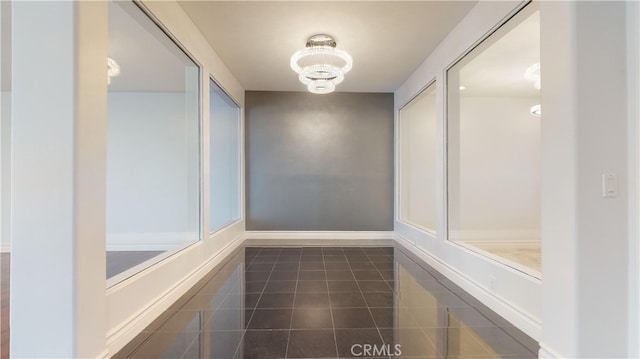 22500 N Summit Ridge Cir, Chatsworth, CA 91311 - hallway with a chandelier and dark tile patterned floors