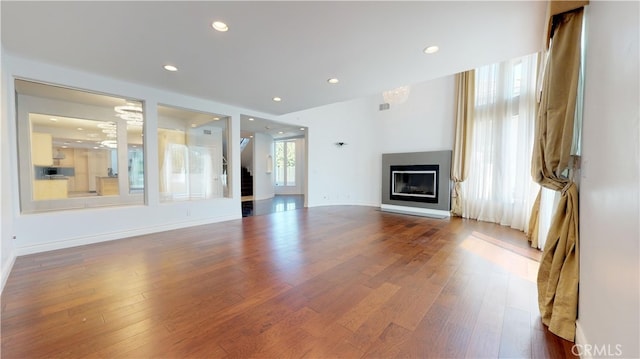 22500 N Summit Ridge Cir, Chatsworth, CA 91311 - unfurnished living room with dark wood finished floors, a glass covered fireplace, and recessed lighting