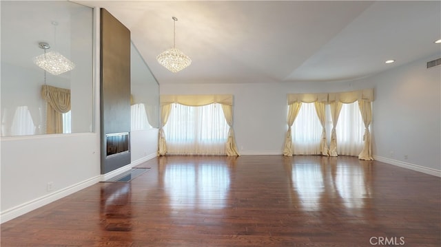 22500 N Summit Ridge Cir, Chatsworth, CA 91311 - empty room with plenty of natural light, a chandelier, wood finished floors, lofted ceiling, and recessed lighting