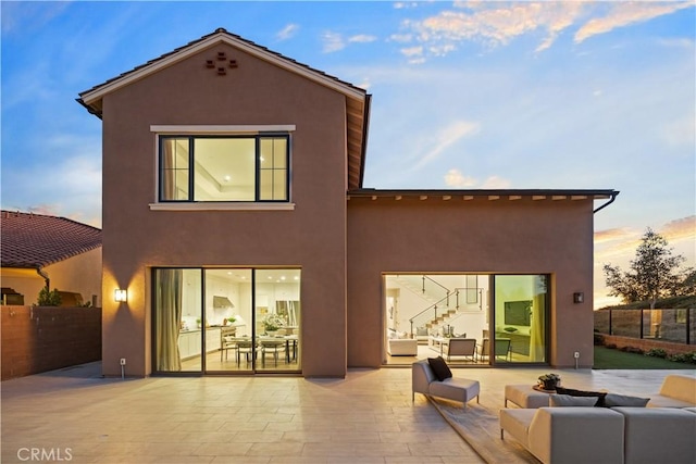 101 Lustro, Irvine, CA 92602 - rear view of property featuring a patio, stucco siding, an outdoor living space, and stairs