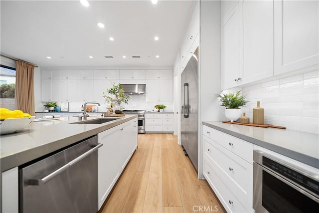 101 Lustro, Irvine, CA 92602 - kitchen featuring high quality appliances, range hood, white cabinetry, and recessed lighting