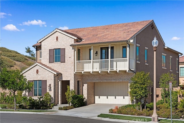 101 Lustro, Irvine, CA 92602 - view of front of home with concrete driveway, brick siding, and an attached garage