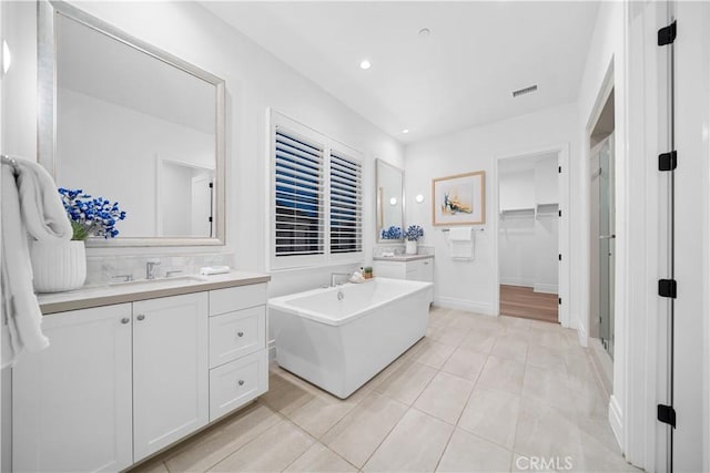 101 Lustro, Irvine, CA 92602 - bathroom with vanity, a freestanding tub, recessed lighting, a stall shower, and a spacious closet