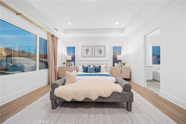 101 Lustro, Irvine, CA 92602 - bedroom featuring light wood-type flooring and a raised ceiling