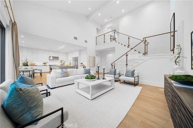 101 Lustro, Irvine, CA 92602 - living area with recessed lighting, light wood finished floors, stairs, and a high ceiling