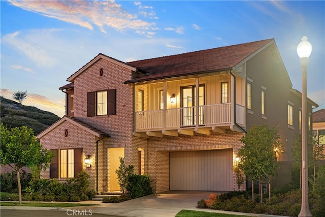 101 Lustro, Irvine, CA 92602 - view of front facade with driveway, a garage, brick siding, and board and batten siding