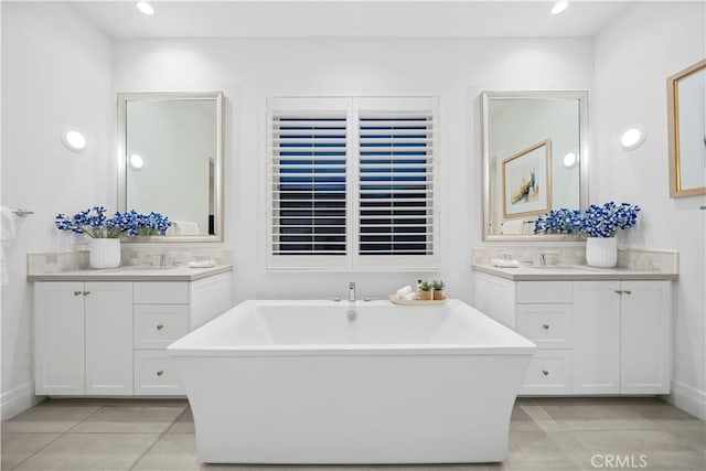 101 Lustro, Irvine, CA 92602 - bathroom featuring a freestanding bath, tile patterned flooring, two vanities, and recessed lighting