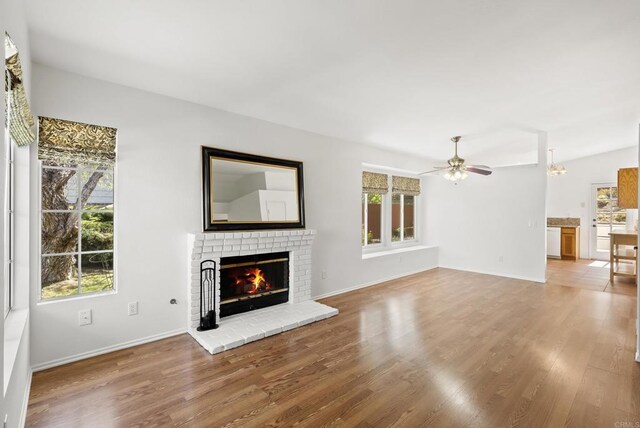 2009 Pointer Gln, Escondido, CA 92029 - unfurnished living room featuring a fireplace, wood finished floors, ceiling fan, and a chandelier