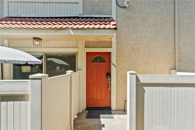 10155 De Soto Ave Unit 104, Chatsworth, CA 91311 - view of exterior entry with a tiled roof and stucco siding