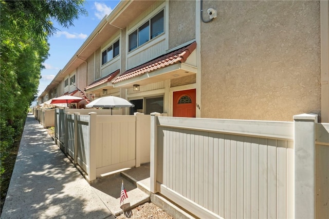 10155 De Soto Ave Unit 104, Chatsworth, CA 91311 - view of home's exterior with stucco siding and a security system