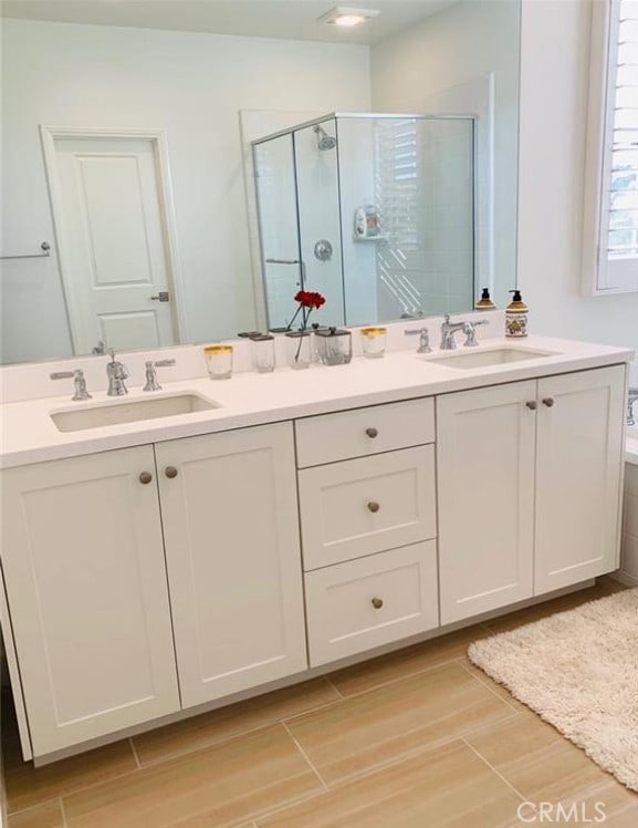 111 Omar, Irvine, CA 92620 - full bath with double vanity, a stall shower, and wood finished floors