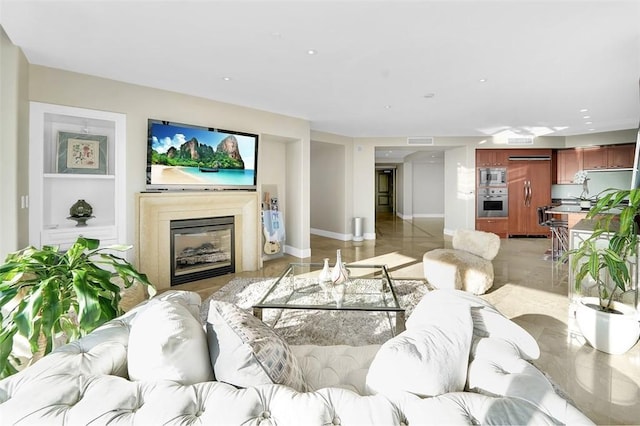 5124 Scholarship Unit 1007, Irvine, CA 92612 - living room featuring a glass covered fireplace