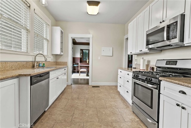 3354 Orange St, Riverside, CA 92501 - kitchen featuring stainless steel appliances, white cabinets, glass insert cabinets, and light countertops