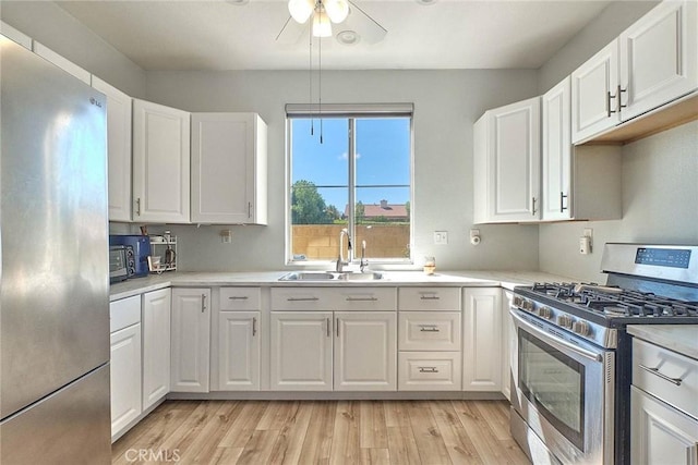 25401 Holly Beach Dr, Saugus, CA 91350 - kitchen with appliances with stainless steel finishes, white cabinets, and light countertops