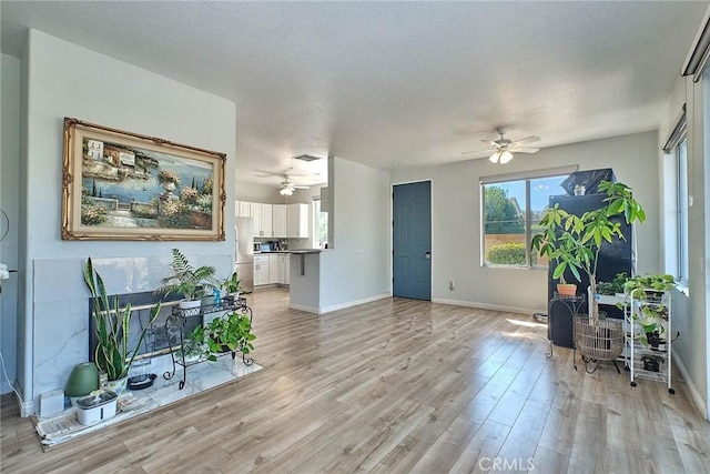 25401 Holly Beach Dr, Saugus, CA 91350 - living room with ceiling fan, light wood-style floors, and healthy amount of natural light