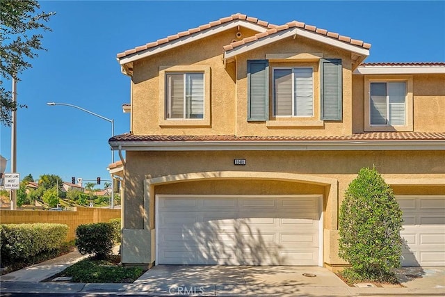 25401 Holly Beach Dr, Saugus, CA 91350 - view of front of home featuring a tile roof, stucco siding, driveway, and a garage