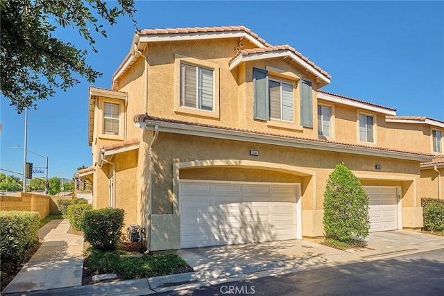 25401 Holly Beach Dr, Saugus, CA 91350 - view of front of home with concrete driveway, a garage, stucco siding, and a tiled roof