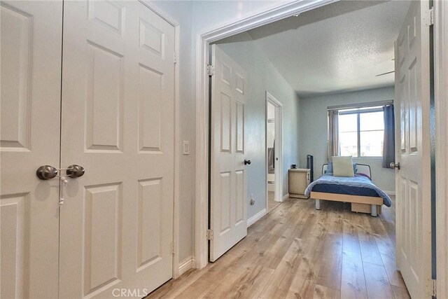 25401 Holly Beach Dr, Saugus, CA 91350 - bedroom featuring light wood-style flooring and a textured ceiling